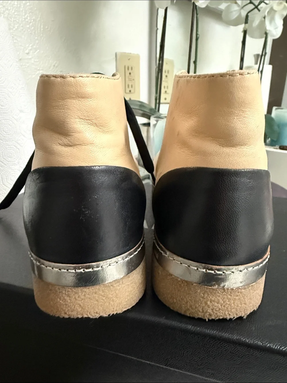 CHANEL Two-Tone Leather High-Top Sneakers in Beige & Black